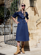 a lady wears a denim shirt with a matching midi skirt
